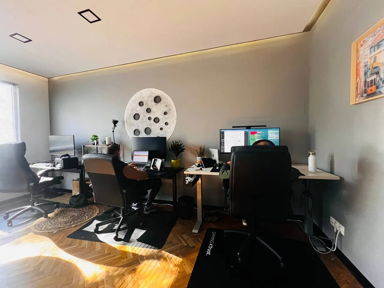 People working at desks with external monitors in Codeburg’s shared workspace